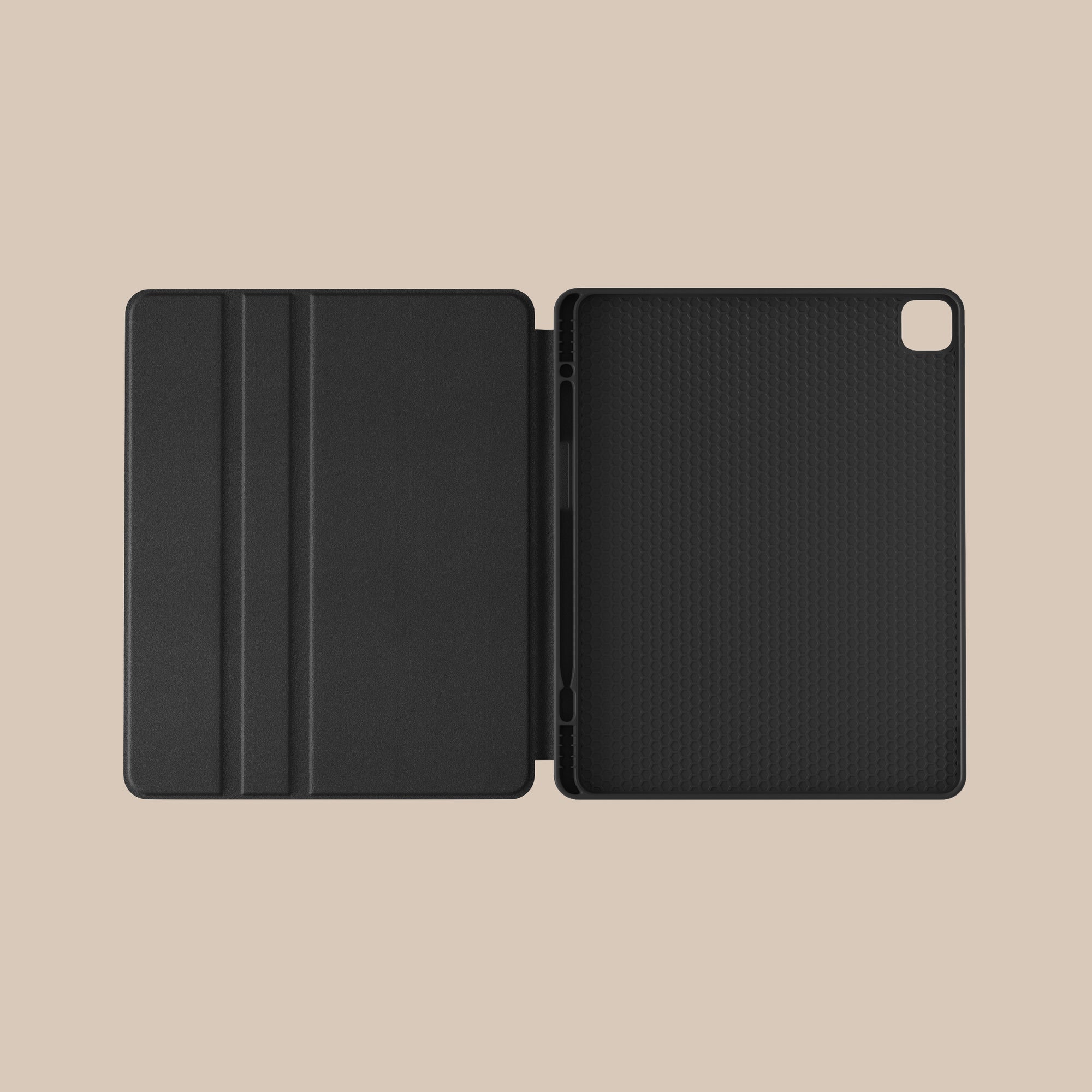 a black ipad case is open on a beige background